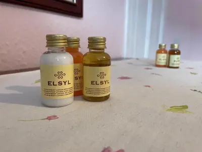 three bottles of essential oils sitting on a table at Charming Cosy Traditional Scottish Cottage - Pass the Keys in Castle Douglas