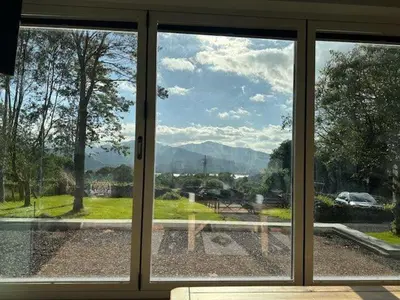 a sliding glass door with a view of a city at Swallows Lodge in Keswick