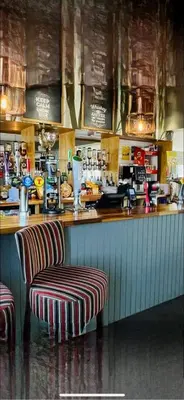 a bar with two stools and a counter in a restaurant at Turnberry Holiday Park in Turnberry