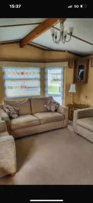 a living room with a couch and a window at Turnberry Holiday Park in Turnberry