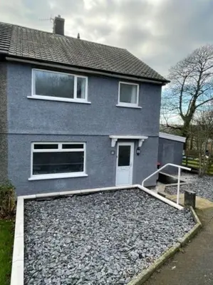 a house with a lot of gravel in front of it at Large 3 bed property in Whitehaven