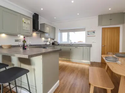 a kitchen and dining room with a counter and a table at 2 South Street in Wigton