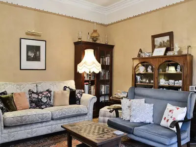 a living room with two couches and a table at Ewes Schoolhouse in Bentpath
