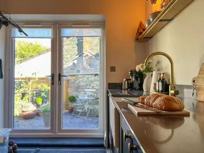 a kitchen with a loaf of bread on a counter at Anley Cottage with garden and private parking in Keswick in Keswick