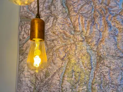a light bulb hanging on a map at Anley Cottage with garden and private parking in Keswick in Keswick