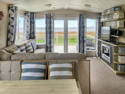 a living room with a couch and a table at Seaview 61-Uk46904 in Mainsriddle