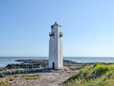 a lighthouse on the shore of the ocean at Seaview 61-Uk46904 in Mainsriddle