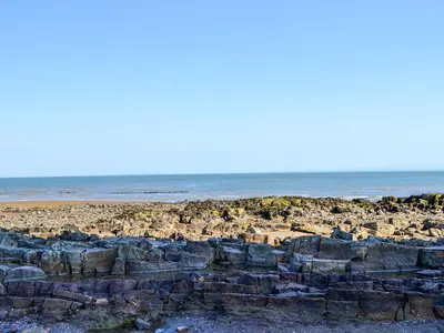 a rocky beach with the ocean in the background at Seaview 61-Uk46904 in Mainsriddle
