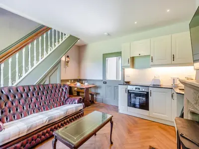 a living room with a couch and a table at The Coach House in Longtown