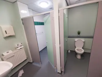 a bathroom with a toilet and a sink at Nine Yards Bell Tents at the TT - Douglas in Douglas