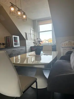 a kitchen with a glass table and a couch at Golfers Rest in Ayr
