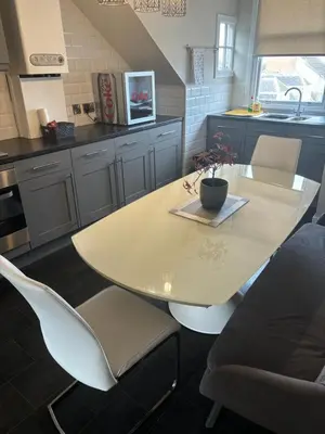 a kitchen with a table and chairs and a sink at Golfers Rest in Ayr