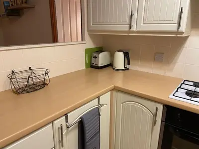 a kitchen with a counter top with a toaster at Livingstones Lodge, Lake District in Plumbland