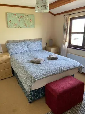 a bedroom with a bed with two pillows on it at Livingstones Lodge, Lake District in Plumbland