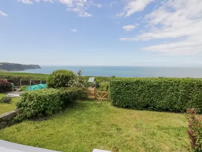 a garden with a view of the ocean at Victroneen Cottage in Whitehaven