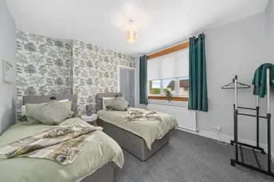a bedroom with two beds and a window at Royal Troon Golf Let in Troon