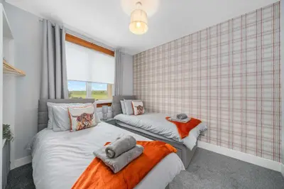 a bedroom with two beds and a window at Royal Troon Golf Let in Troon