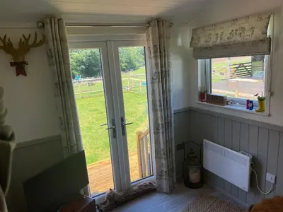 a room with a window and a sliding glass door at Millburn Mini Farm in Kilwinning