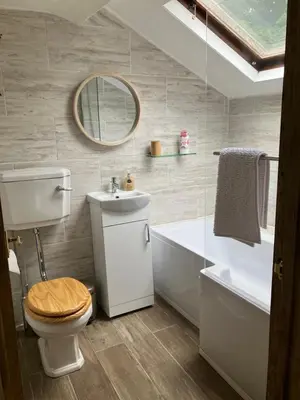 a bathroom with a toilet and a sink and a mirror at Annie's Cottage in Gosforth