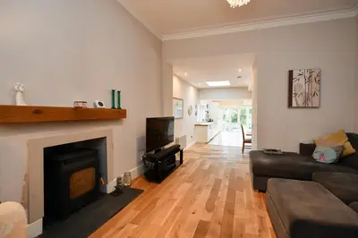 a living room with a couch and a fireplace at Arran View in Prestwick in Prestwick