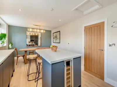 a kitchen and dining room with a island in the middle at Station Street Apartment in Cockermouth