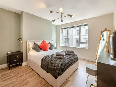 a bedroom with a bed and a window at Station Street Apartment in Cockermouth