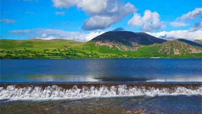 a large body of water with mountains in the background at Newly Renovated 2 Bed Property - Pass the Keys in Cleator Moor