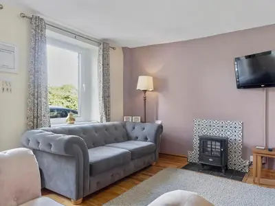 a living room with a couch and a fire place at Newly Renovated 2 Bed Property - Pass the Keys in Cleator Moor