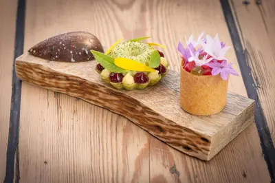 a wooden cutting board with two different types of food at Forest Side Hotel in Grasmere