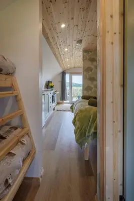 a bedroom with a bed in a room with a window at The Galloway Steading -The Hedgehog's Hideout family cabin with Hot Tub and Fire Pit in Glenluce
