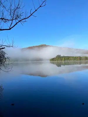 a view of a lake with fog on the water at Rothay Garden by Harbour Hotels in Grasmere