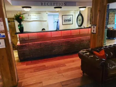 a lobby with a bar in a store with a couch at The Inn At Grasmere in Grasmere