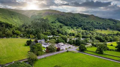 an aerial view of a village in the mountains at The Swan at Grasmere- The Inn Collection Group in Grasmere