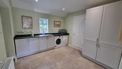 a kitchen with a sink and a washing machine at Lady Farm - Bargany in Girvan
