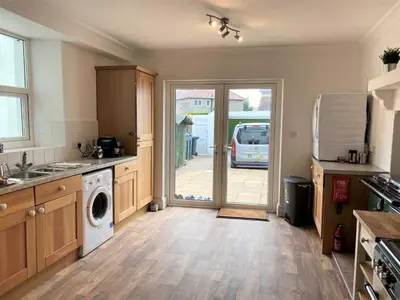 a kitchen with a washer and a door to a garage at Tre in Douglas