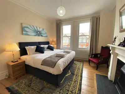 a bedroom with a large bed and a fireplace at Tre in Douglas