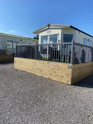 a wooden fence in front of a house at 19 Forest Views in Plumbland