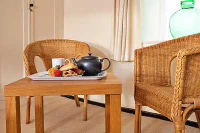 a plate of food on a table with a tea pot at Finest Retreats - Town Head Cottage in Grasmere in Grasmere