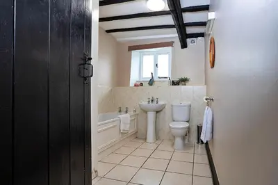 a bathroom with a toilet and a tub and a sink at Finest Retreats - Town Head Cottage in Grasmere in Grasmere