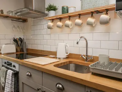 a kitchen with a sink and a counter top at Style Cottage in Keswick