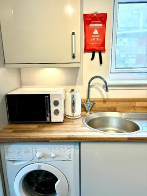 a kitchen with a microwave and a sink at Golf View in Prestwick