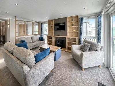 a living room with two couches and a tv at Uk47534 - Sea View 82 in Mainsriddle