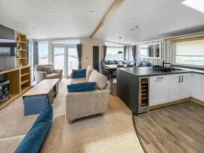 a kitchen and living room with a couch and a table at Uk47534 - Sea View 82 in Mainsriddle