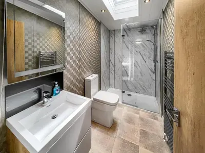 a bathroom with a sink and a toilet and a shower at Uk47534 - Sea View 82 in Mainsriddle