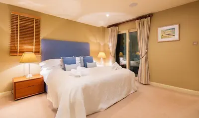 a bedroom with a large white bed and a window at Underscar - Latrigg in Keswick