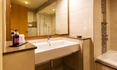 a bathroom with a sink and a shower and a tub at Underscar - Latrigg in Keswick