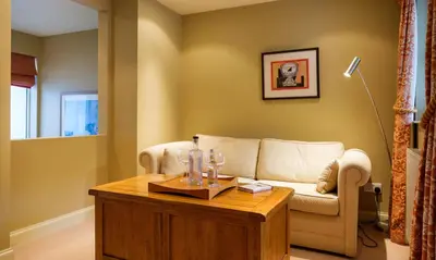 a living room with a couch and a table at Underscar - Manesty in Keswick