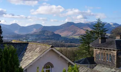 a house with mountains in the background at Underscar - Manesty in Keswick