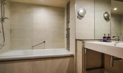 a bathroom with a tub and a sink at Underscar - Manesty in Keswick