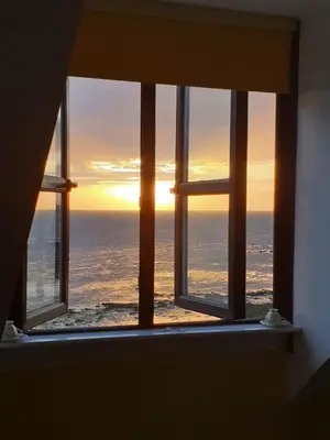 a view of the ocean from a window at The Old Cornstore a beautiful Suite overlooking the sea in Drummore